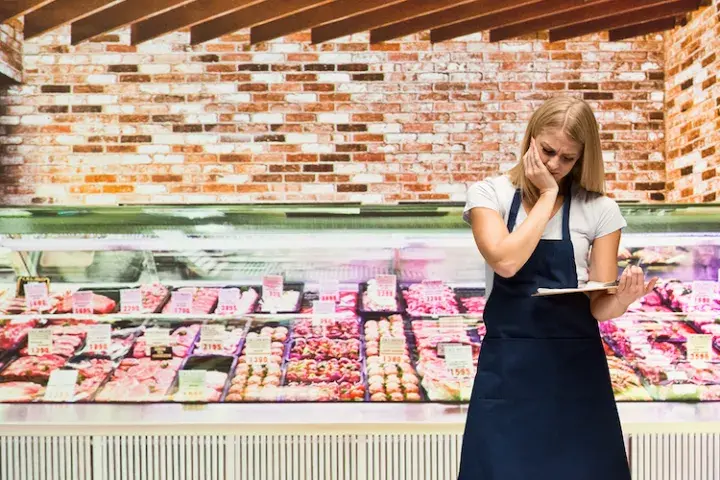 Grocery woman looking at clipboard